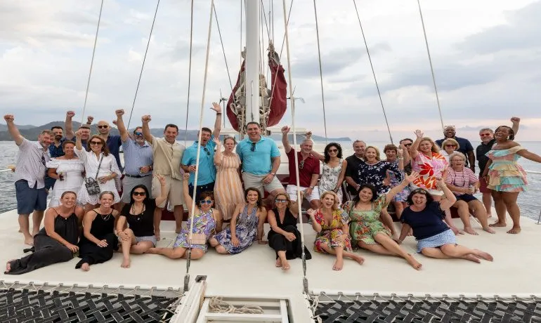 Group of guests gathered on a sailboat during a rewards celebration