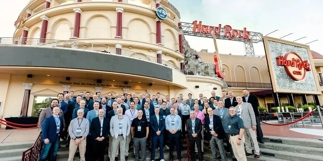 Large group photographed outside an entertainment venue after an event