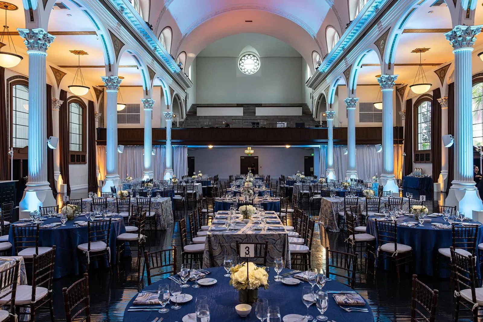 Banquet hall with round tables set under an arched ceiling