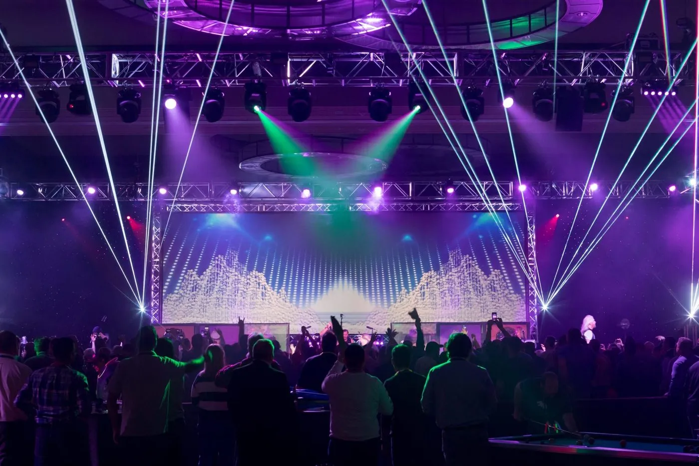 Concert style general session with laser lighting over a large crowd