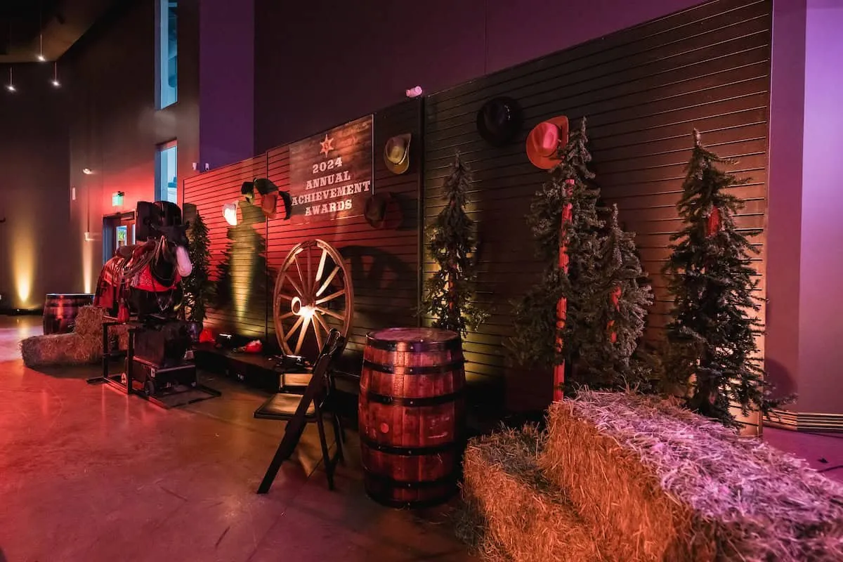 Western-themed awards gala setting with barrels, hay bales and warm lighting for Southern Glazer's