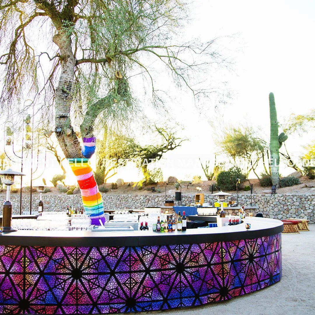Round patterned event bar in a desert garden with a painted cactus
