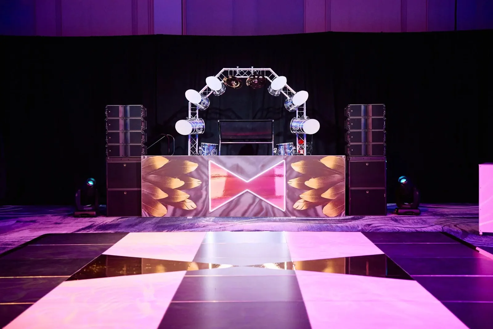 Stage with a DJ booth and a checkered dance floor