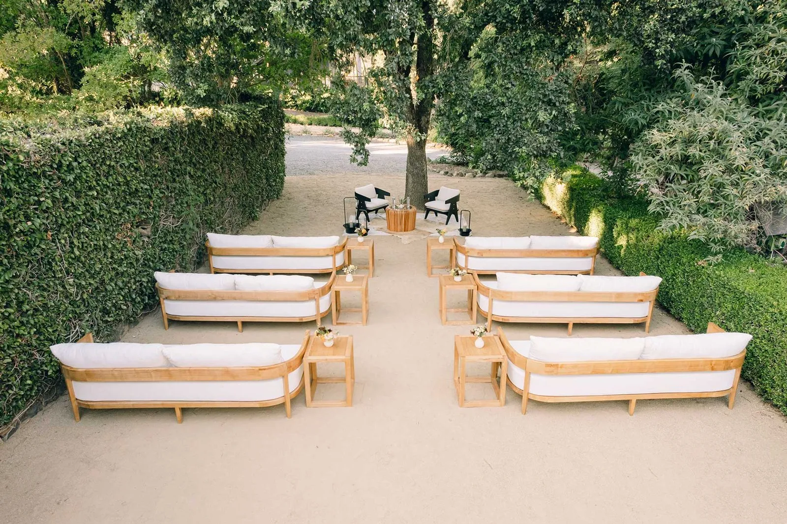 Garden session with rows of white outdoor sofas