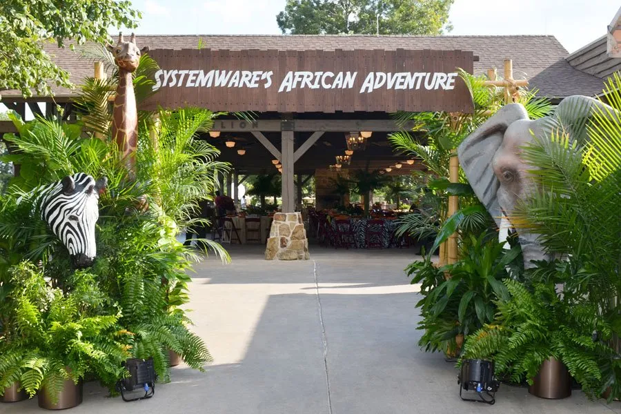 Bamboo safari-themed entrance to an outdoor pavilion at a company family weekend at Lost Pines Resort