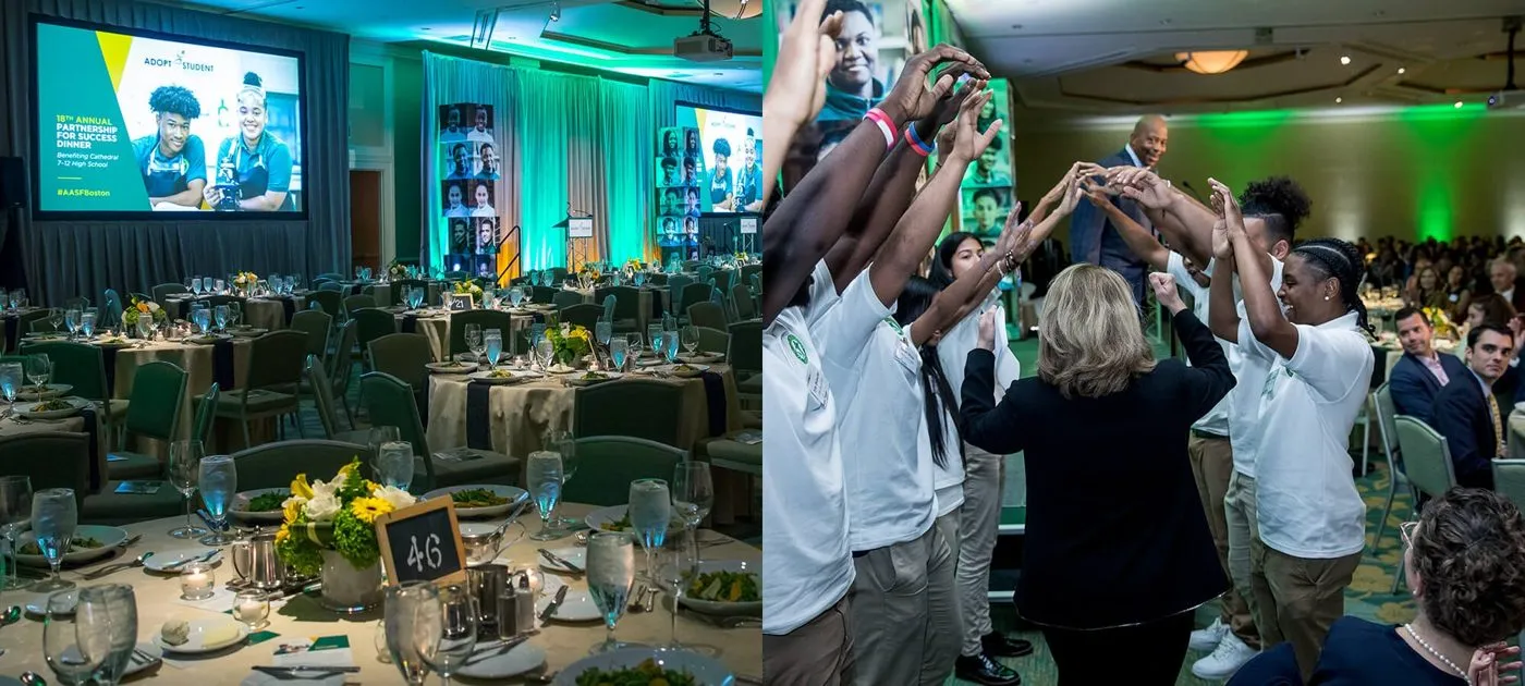 Corporate dinner with a hosted team raising their arms at the table