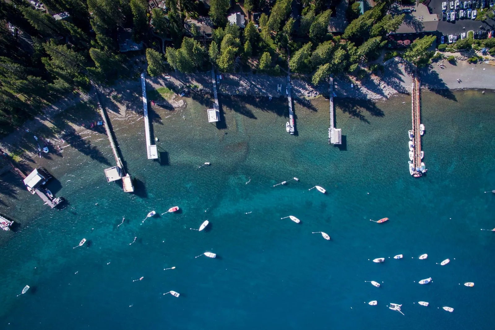 Small boats by wooden piers on Lake Tahoe.