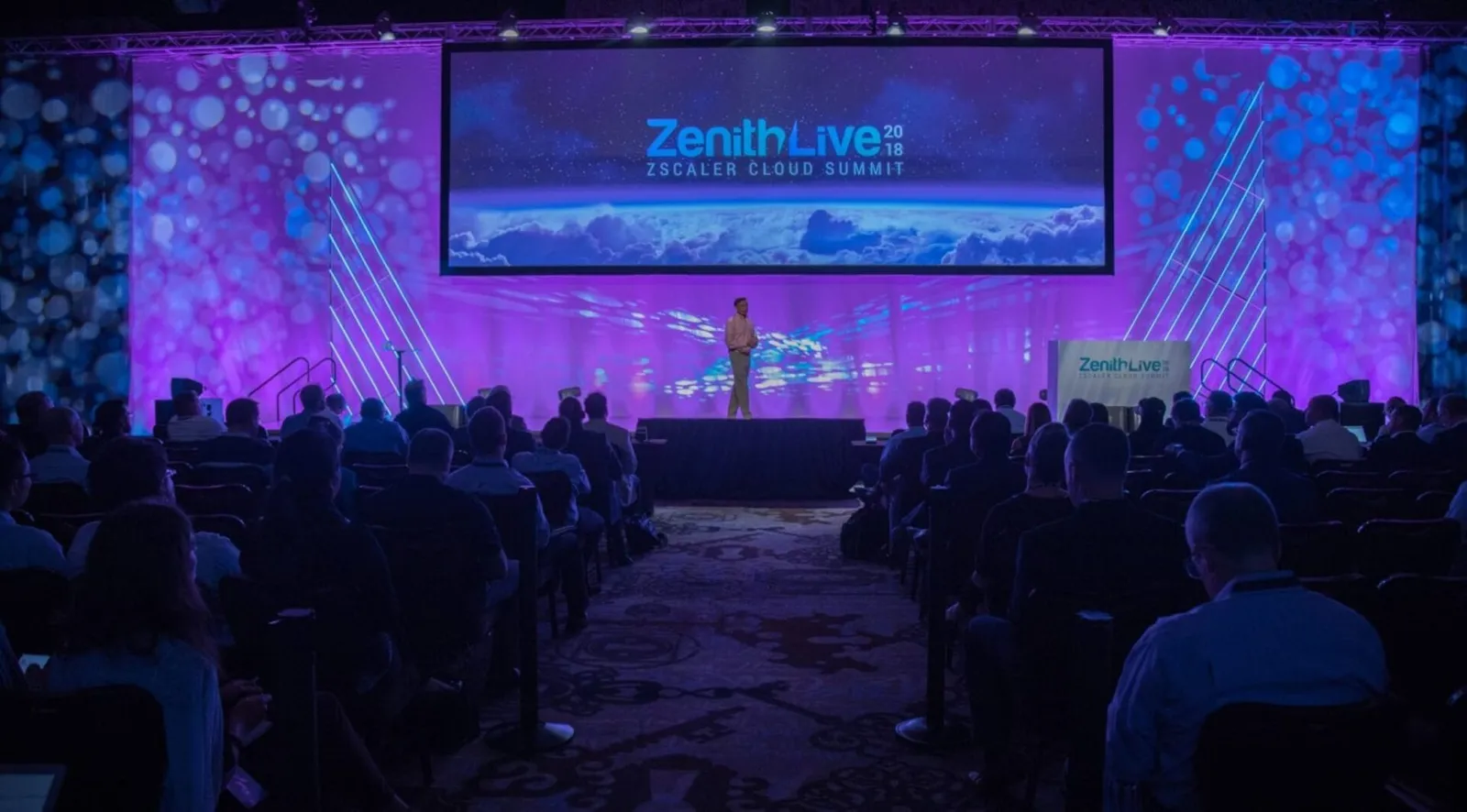 Zenith Live general session with purple stage lighting