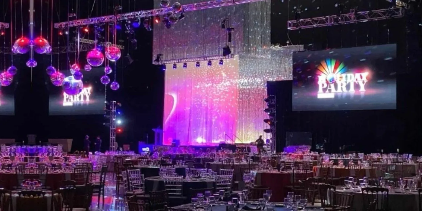 Ballroom gala with hanging ornaments and large stage screens