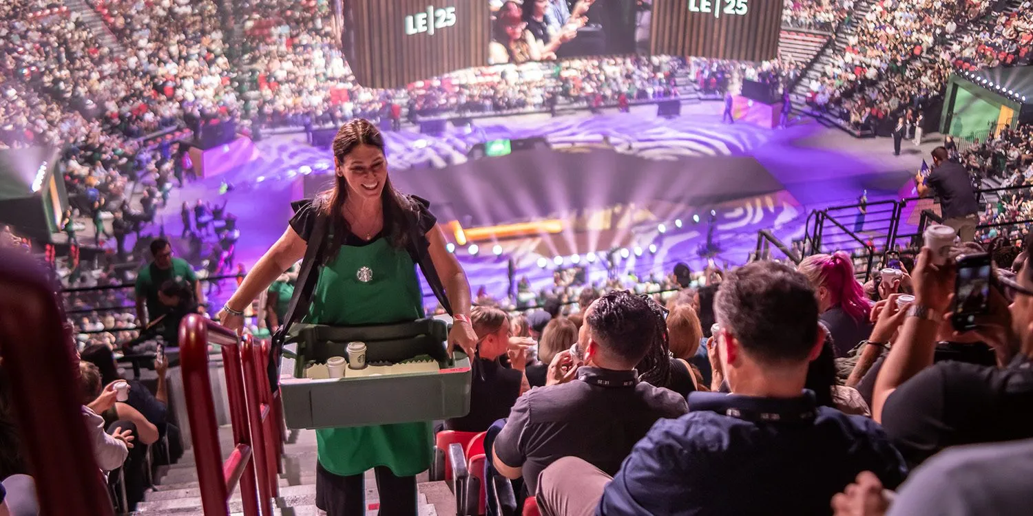 Large audience in an arena at a company leadership event
