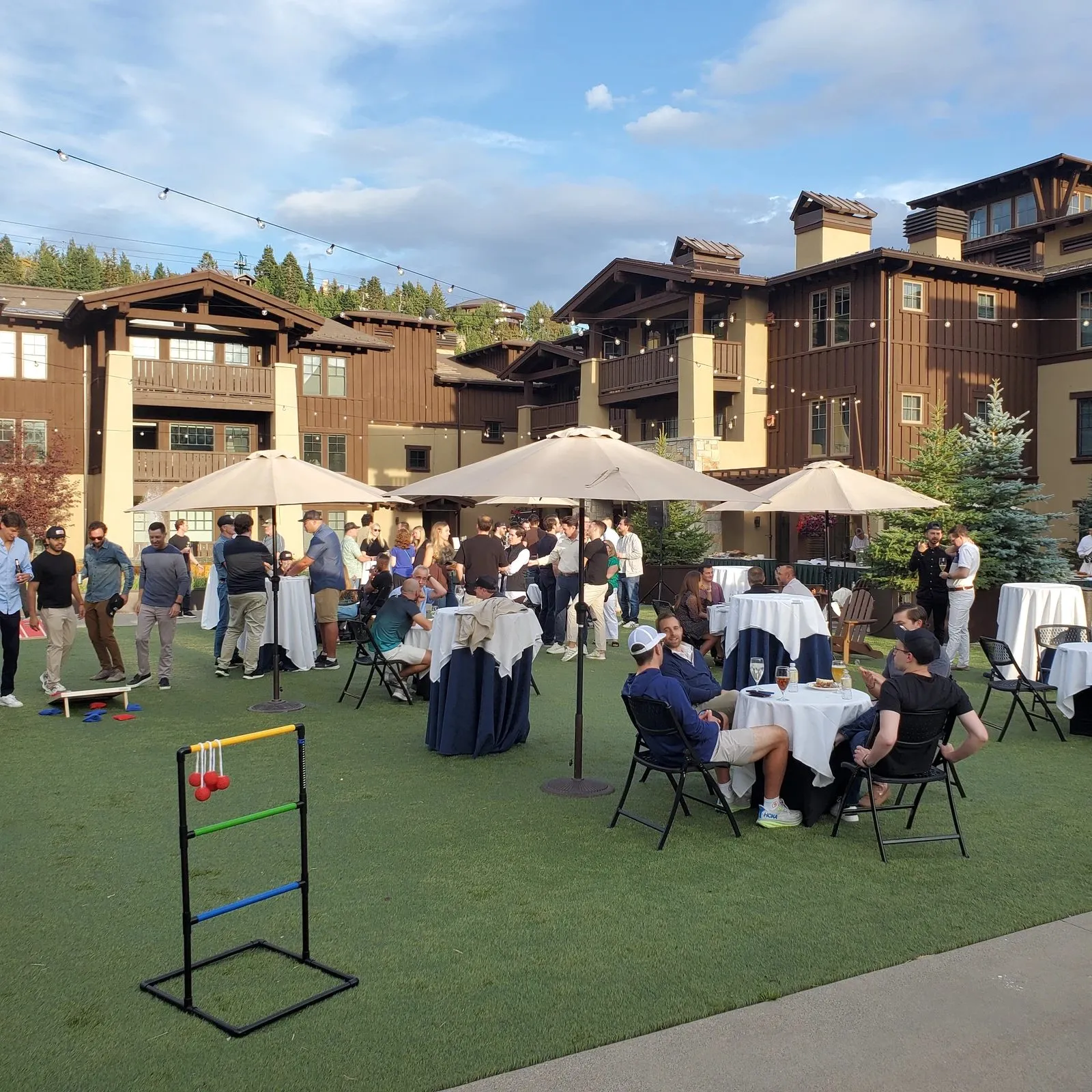 Outdoor corporate reception with seating under umbrellas