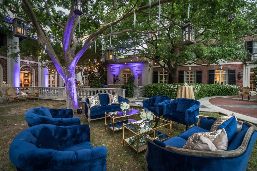 Blue velvet lounge seating beneath uplit trees at the executive retreat