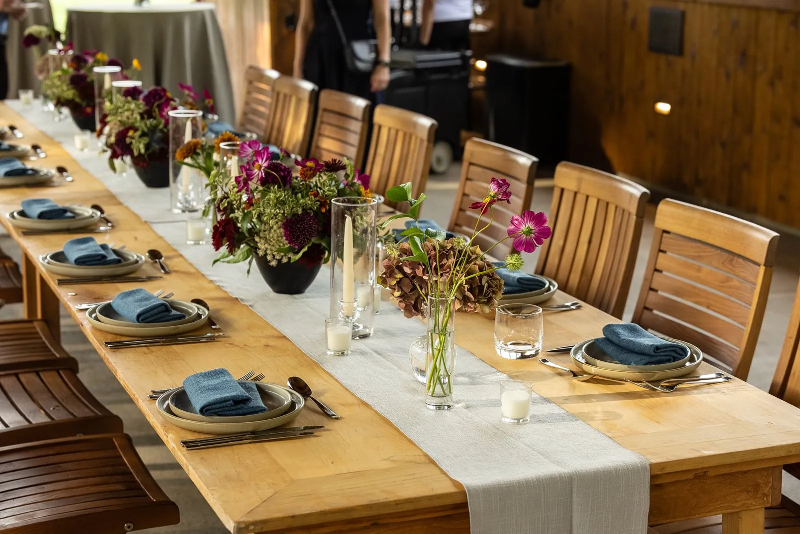 Long wooden tables set for the covered bridge dinner during a Nashville corporate retreat