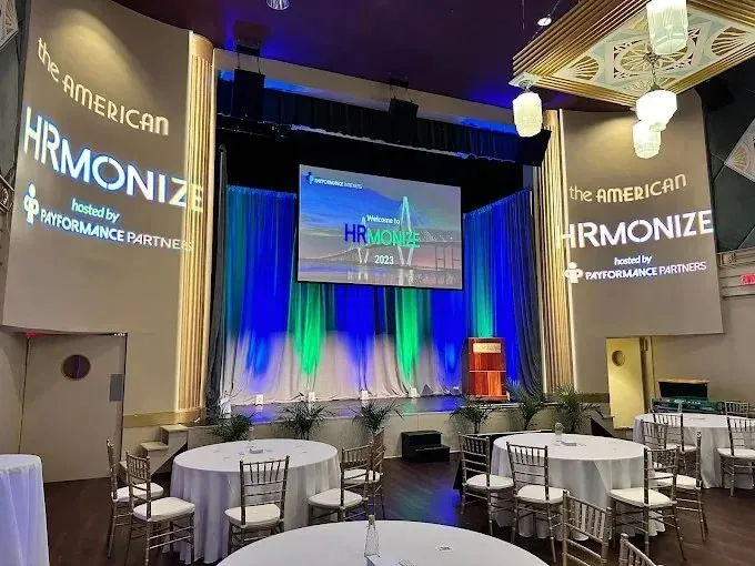 Conference ballroom with a branded stage and side screens