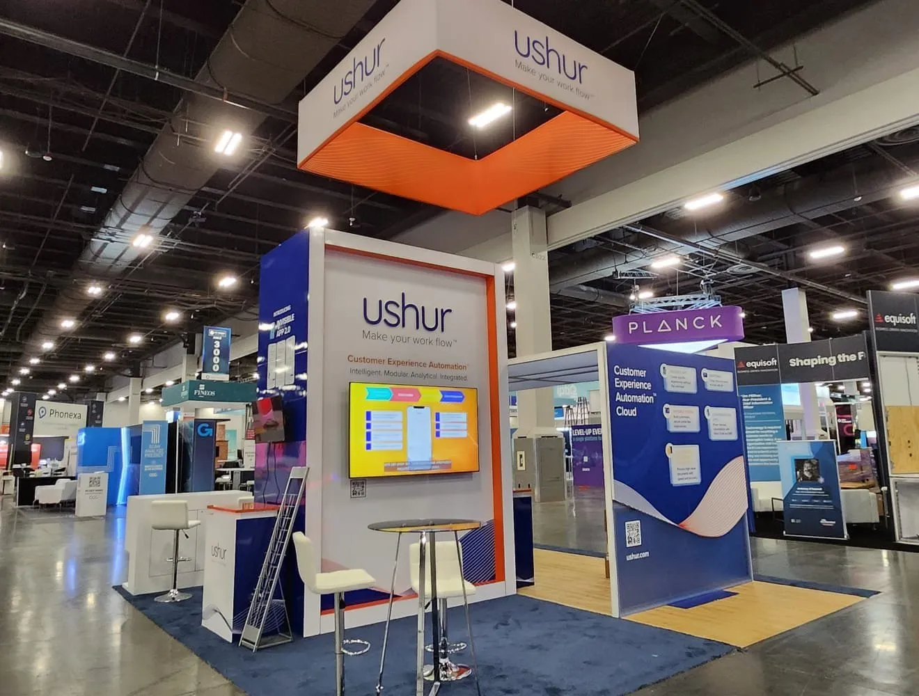 Custom Ushur trade show booth with a hanging sign