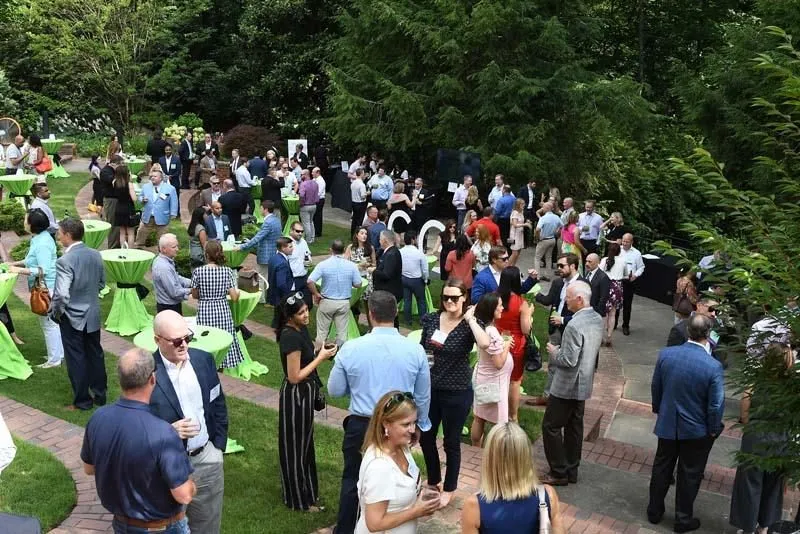 Guests mingling at an outdoor garden reception
