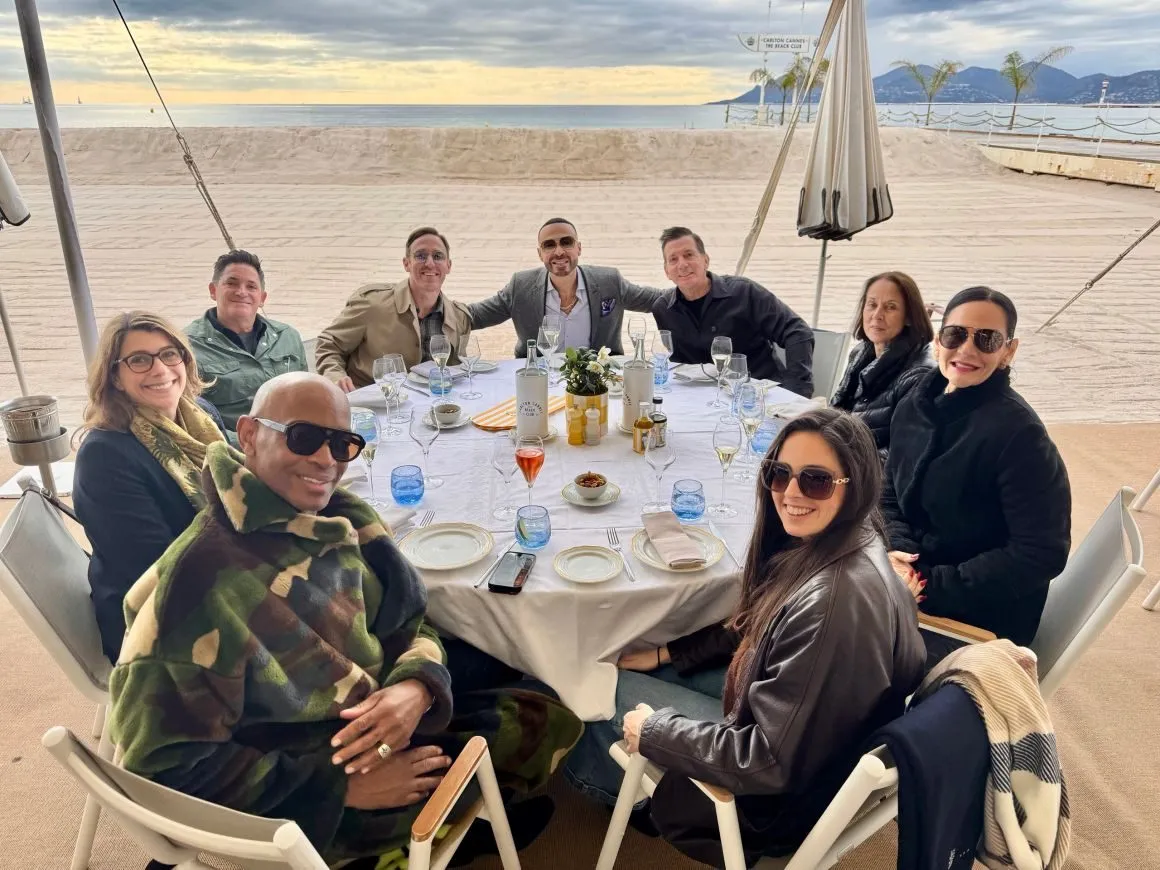 Guests seated at a round table on a beach terrace at an event