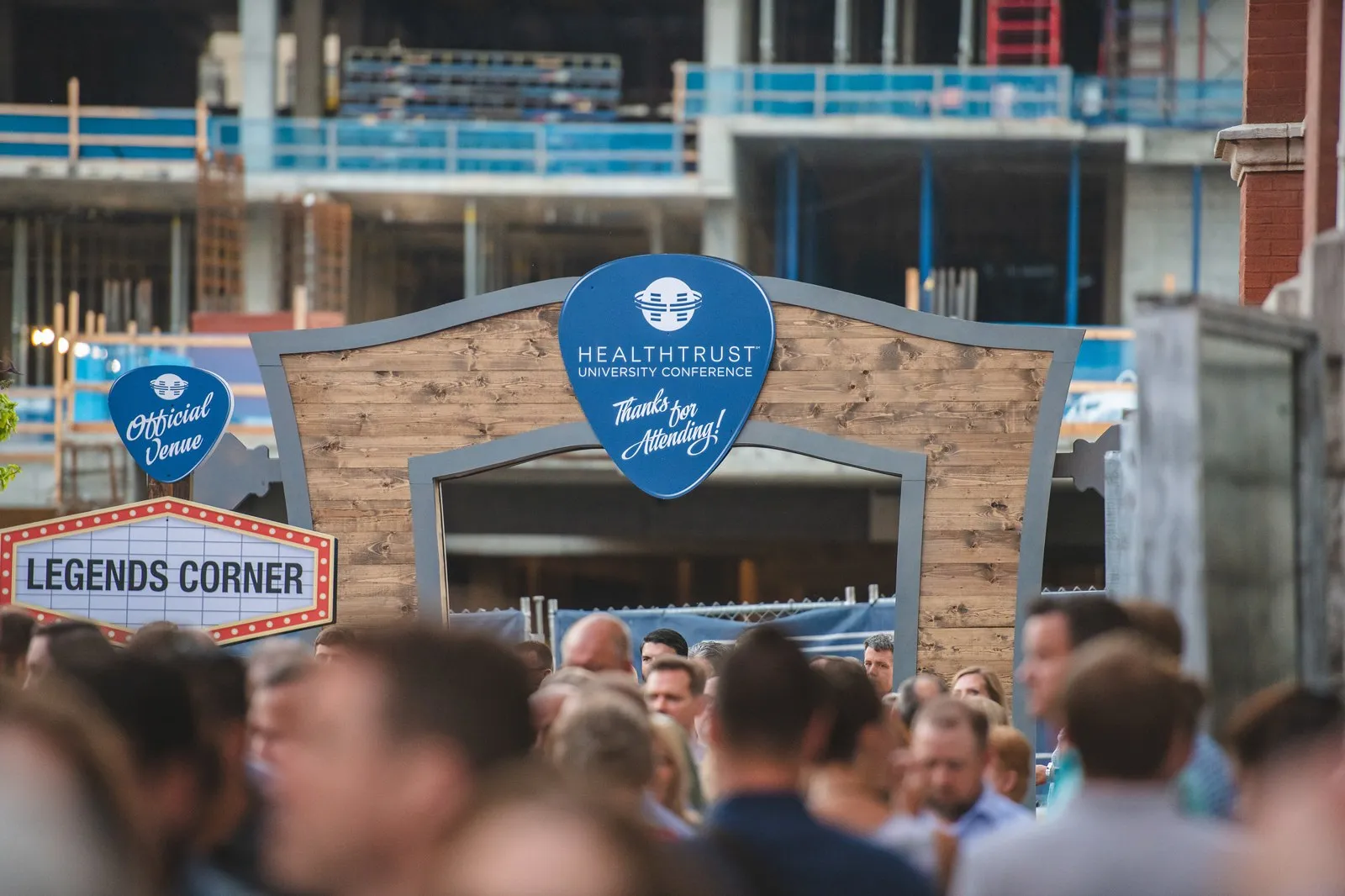 Attendees gathered at a branded outdoor street-party setup
