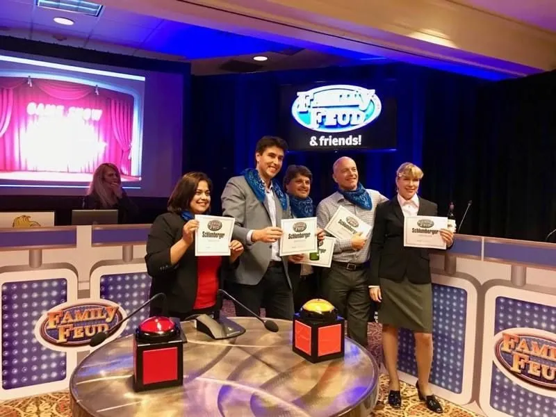 Team on a game show style stage set at a corporate event