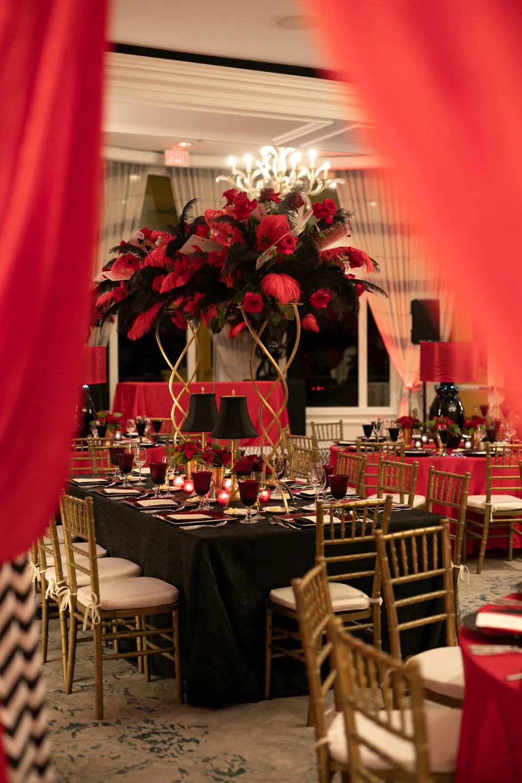 Black and red table setting with floral centerpieces for a gala dinner