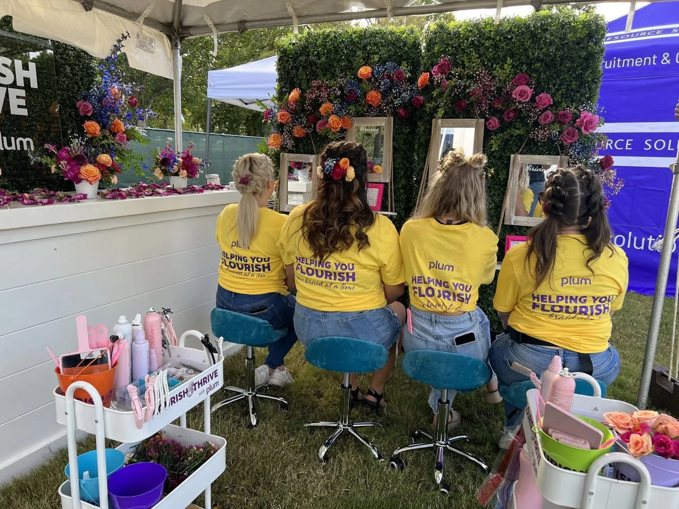 Brand activation team in matching shirts at an outdoor event setup