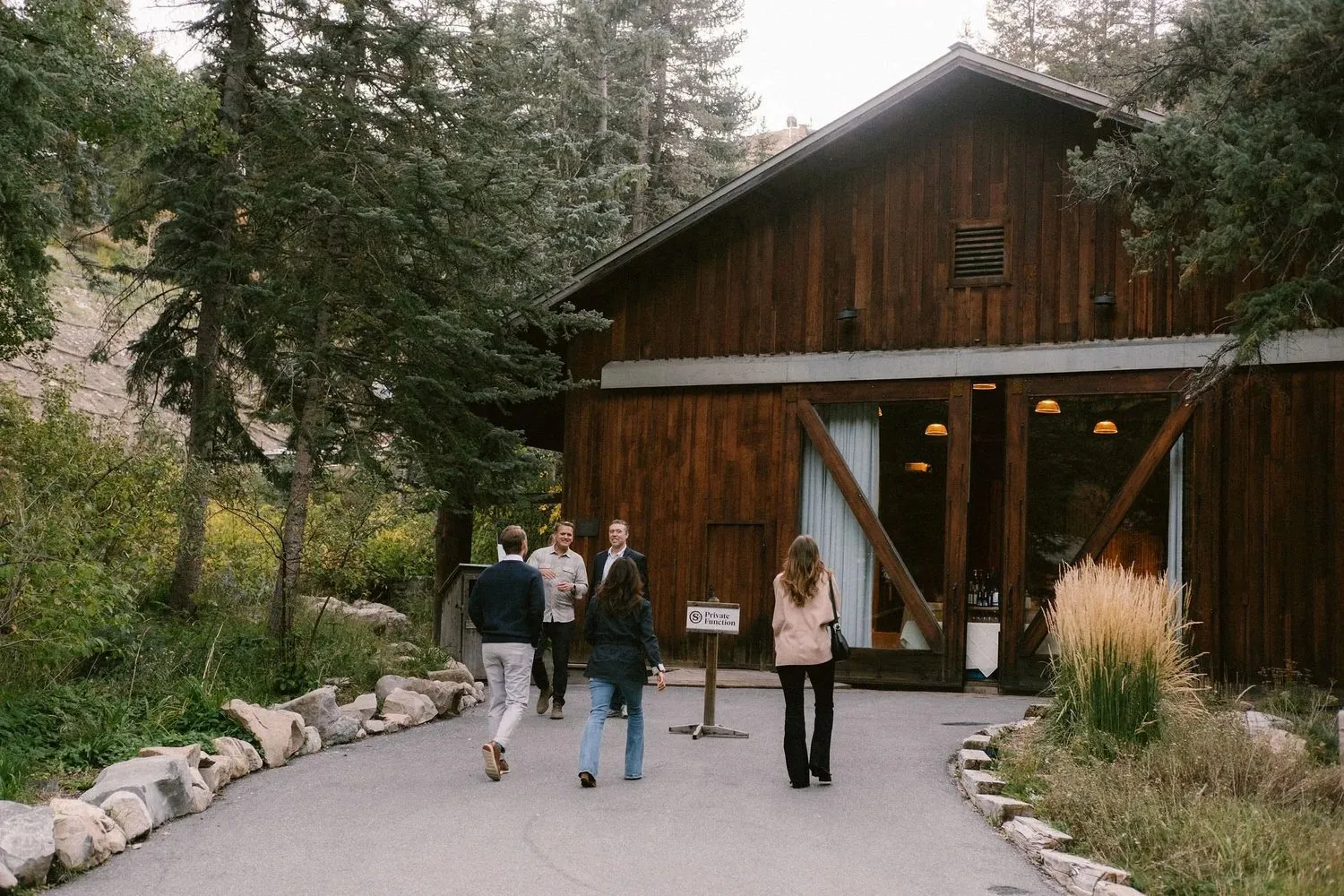 Guests walking to a timber lodge at Sundance Mountain Resort during a corporate retreat