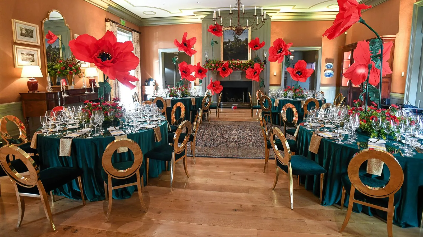 Dinner room with red floral decor and teal table linens