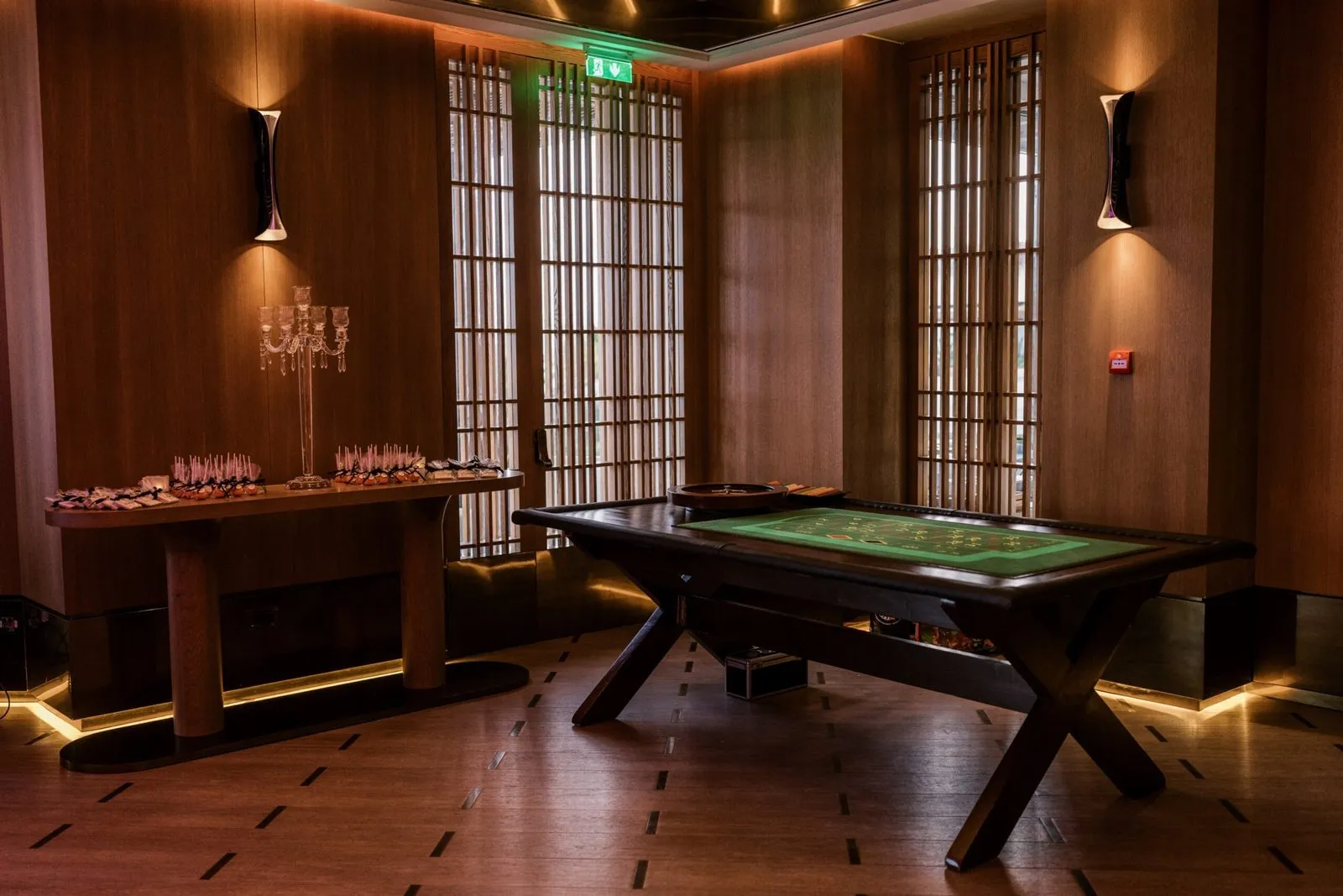 Wood-paneled games room with a felt table at the MaxWeb retreat