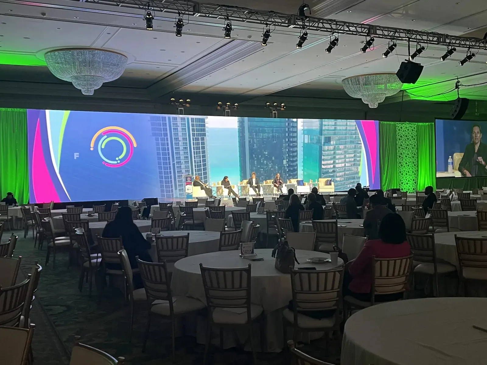 Wide LED video wall behind a panel stage at Trump National Doral, Miami