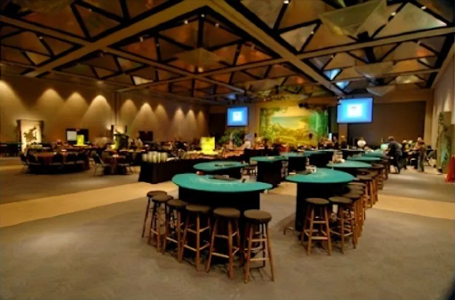 Casino themed event hall with gaming tables and bar stools