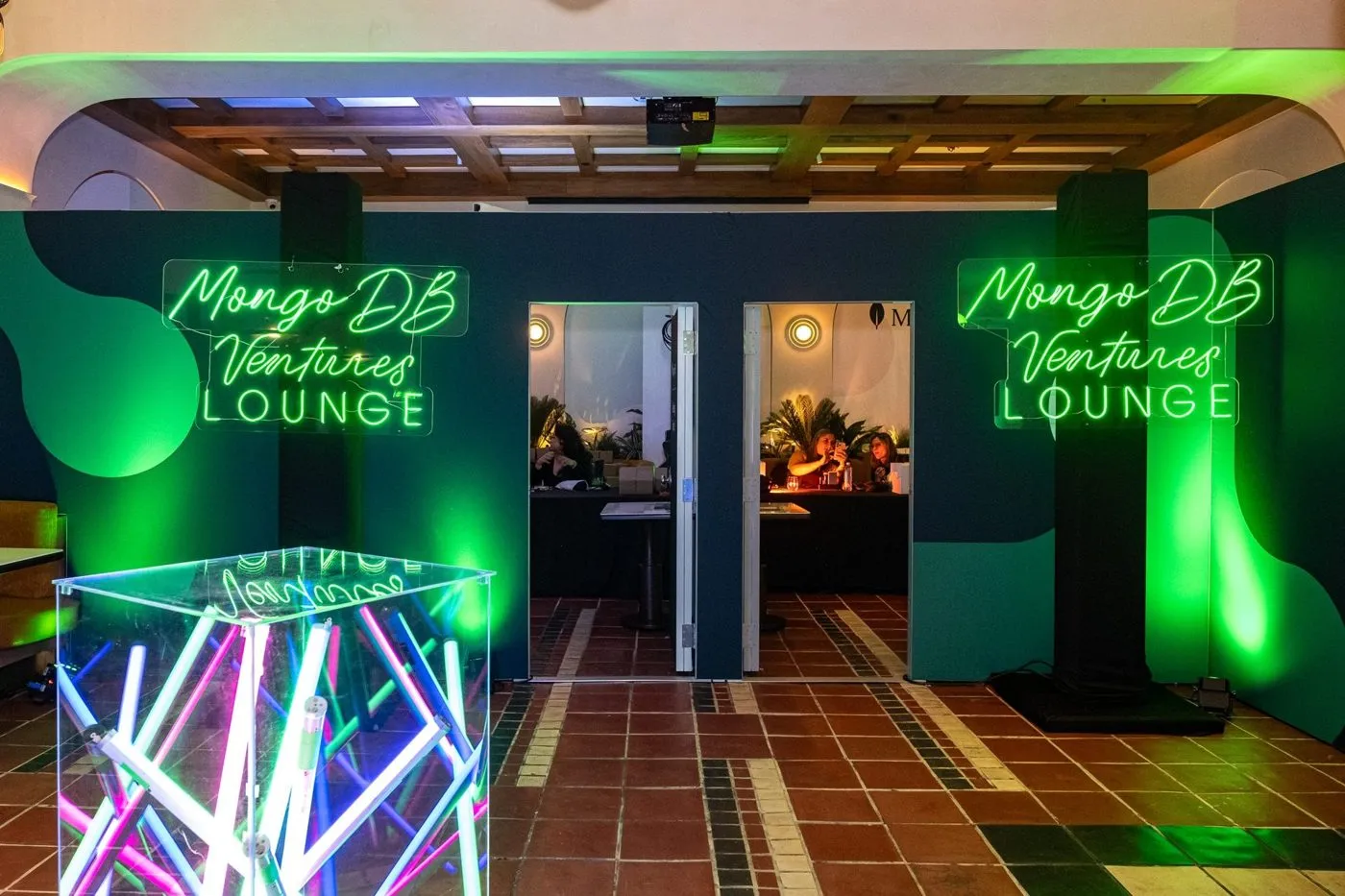 Green lit branded lounge entrance built for a technology company event