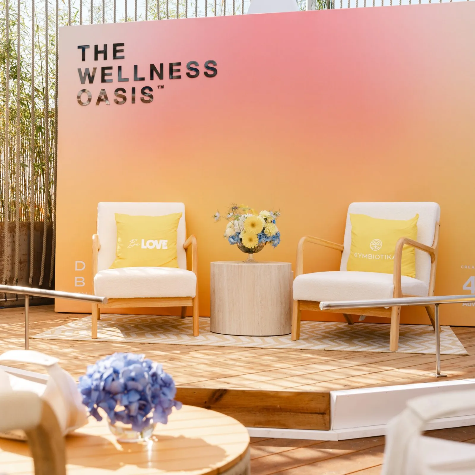 Branded stage set with two chairs and a colorful backdrop