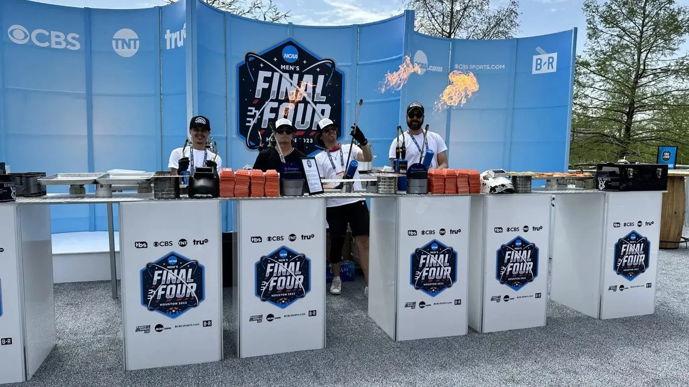 Branded hospitality tent with staff at a sporting event