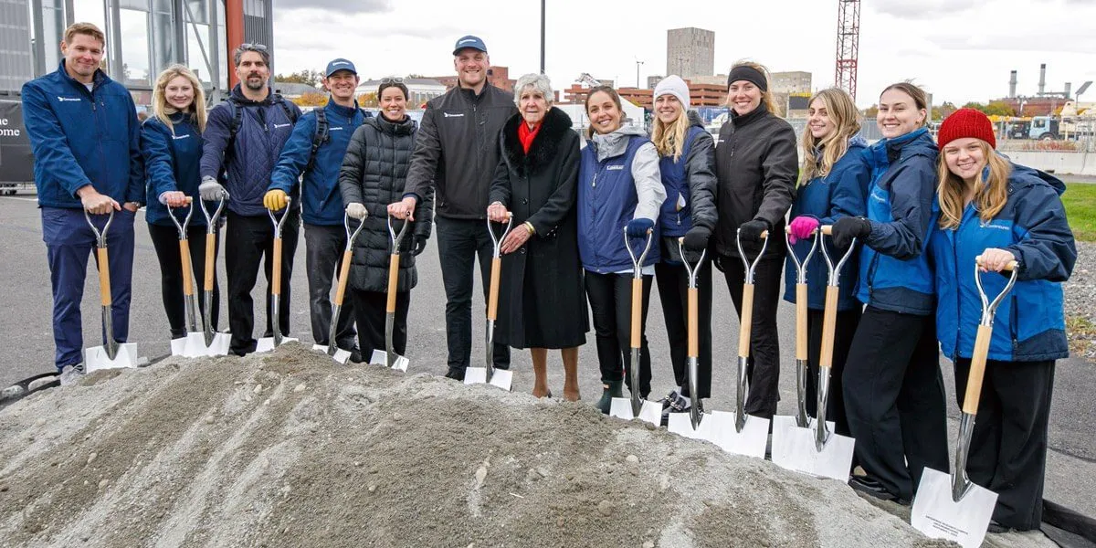Executives with shovels at a groundbreaking ceremony