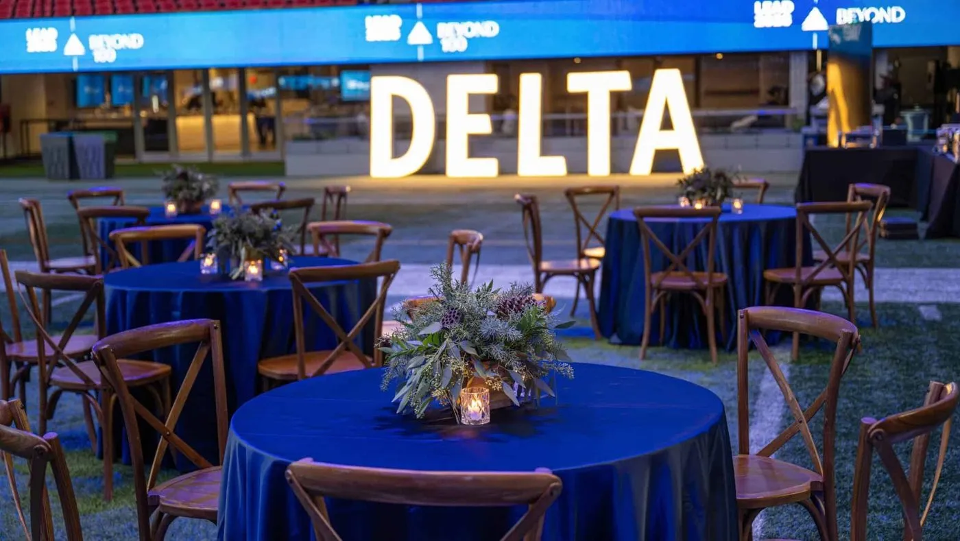 Round tables with an illuminated sign at a corporate conference event