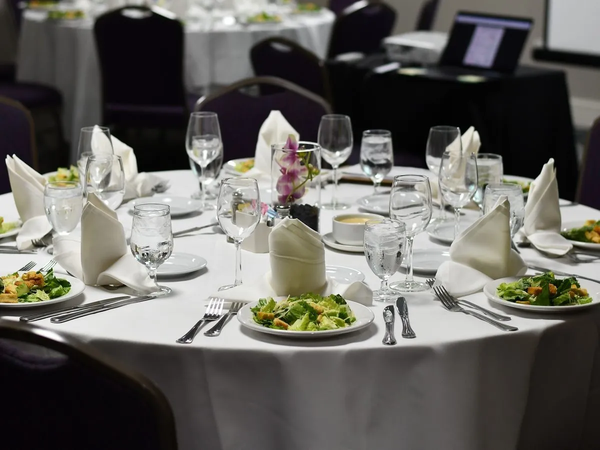 Conference luncheon tables set with place settings and menus