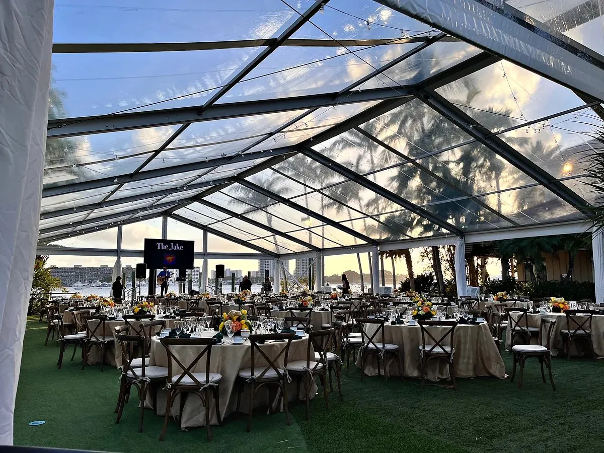 Clear-span tent with round tables set on a lawn