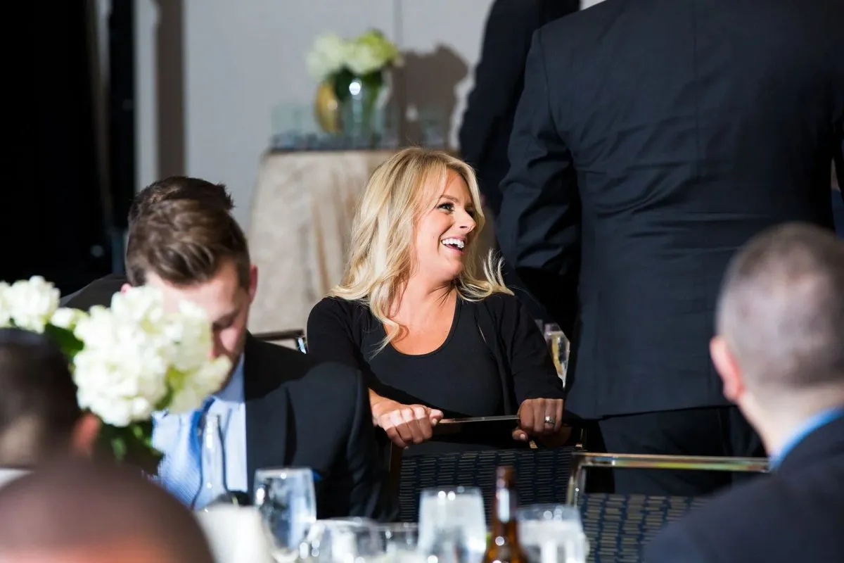 Guests seated and talking at a reception table