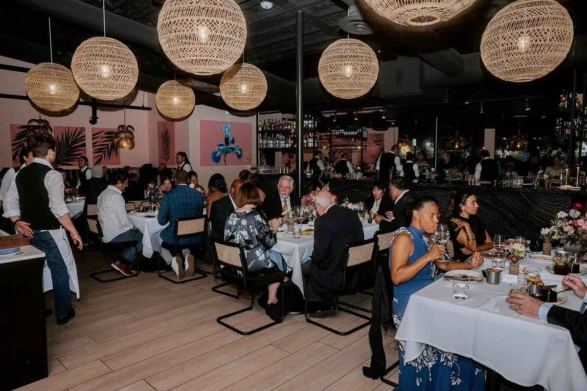 Seated dinner in a restaurant under woven pendant lights
