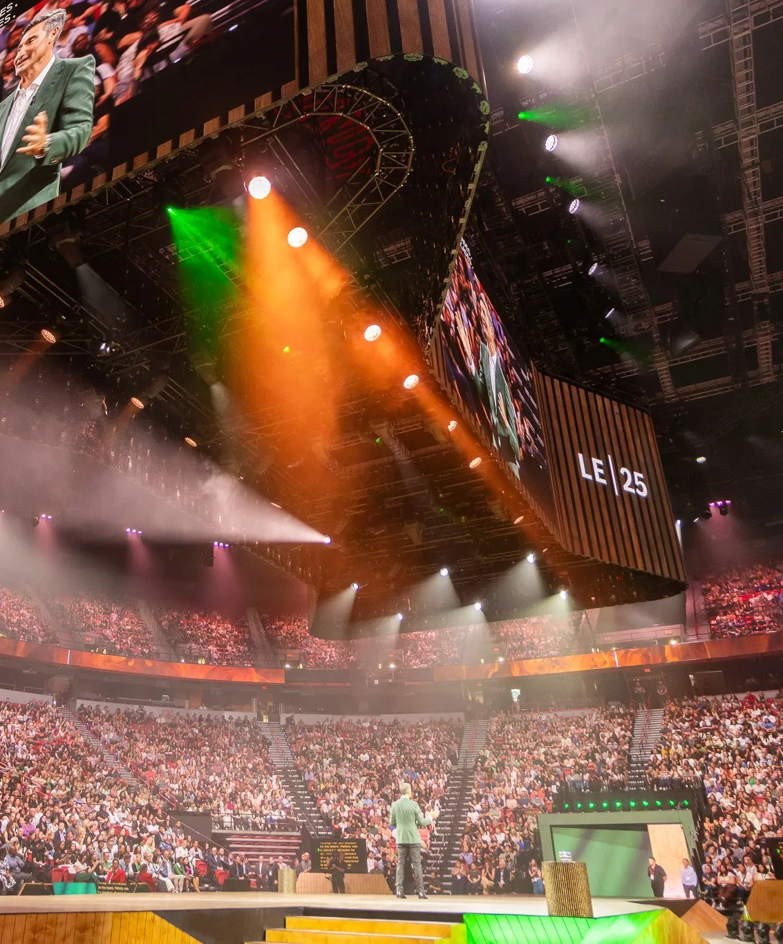 Main stage with lighting and a full audience at a company event