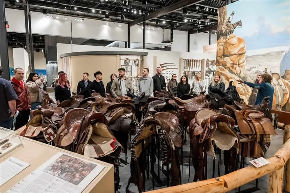 Retreat guests touring a saddle display at Scottsdale's Museum of the West on the night of the retreat dinner