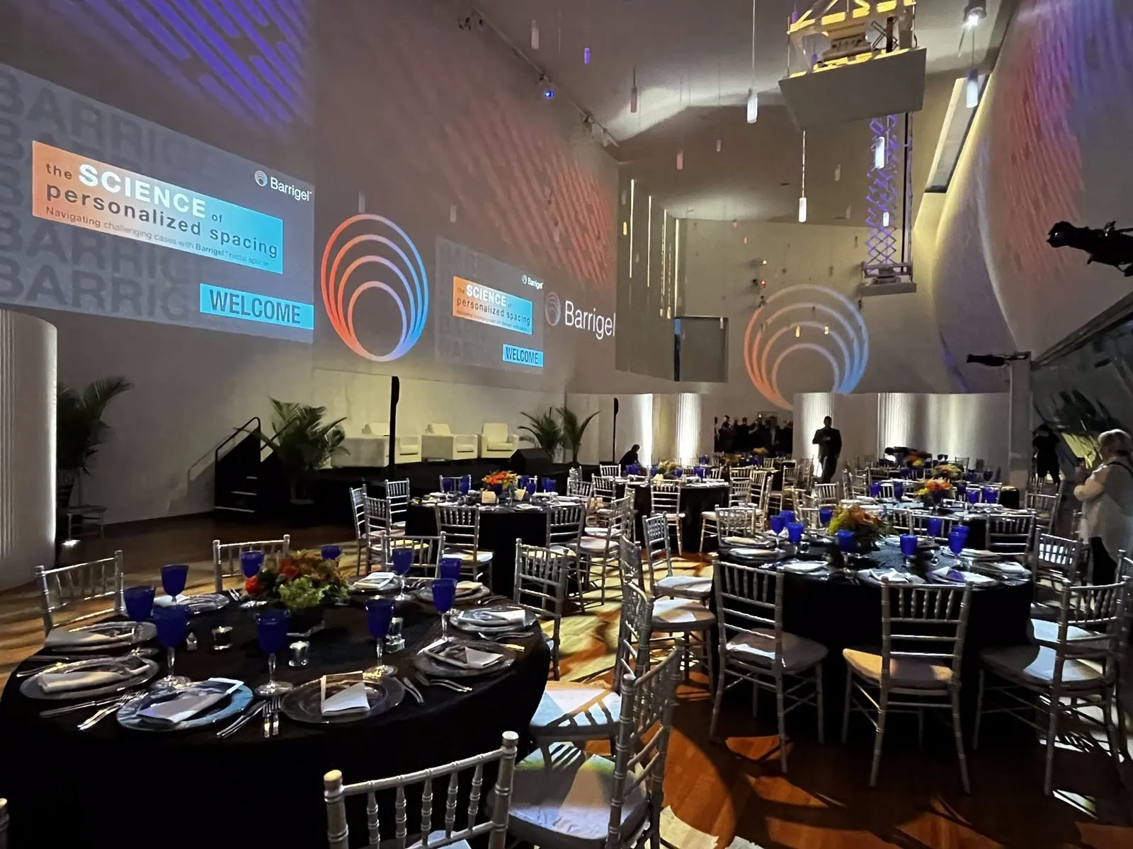 Corporate gala dinner with branded projections and set tables