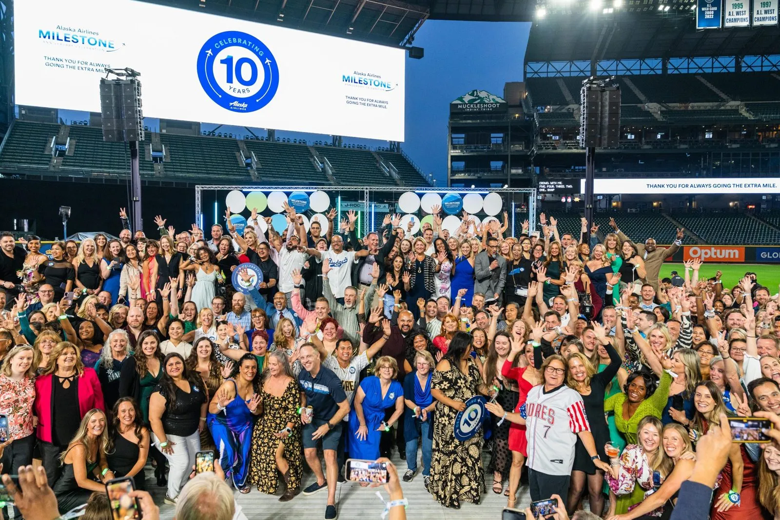Large group of attendees gathered in front of a stage at a stadium conference