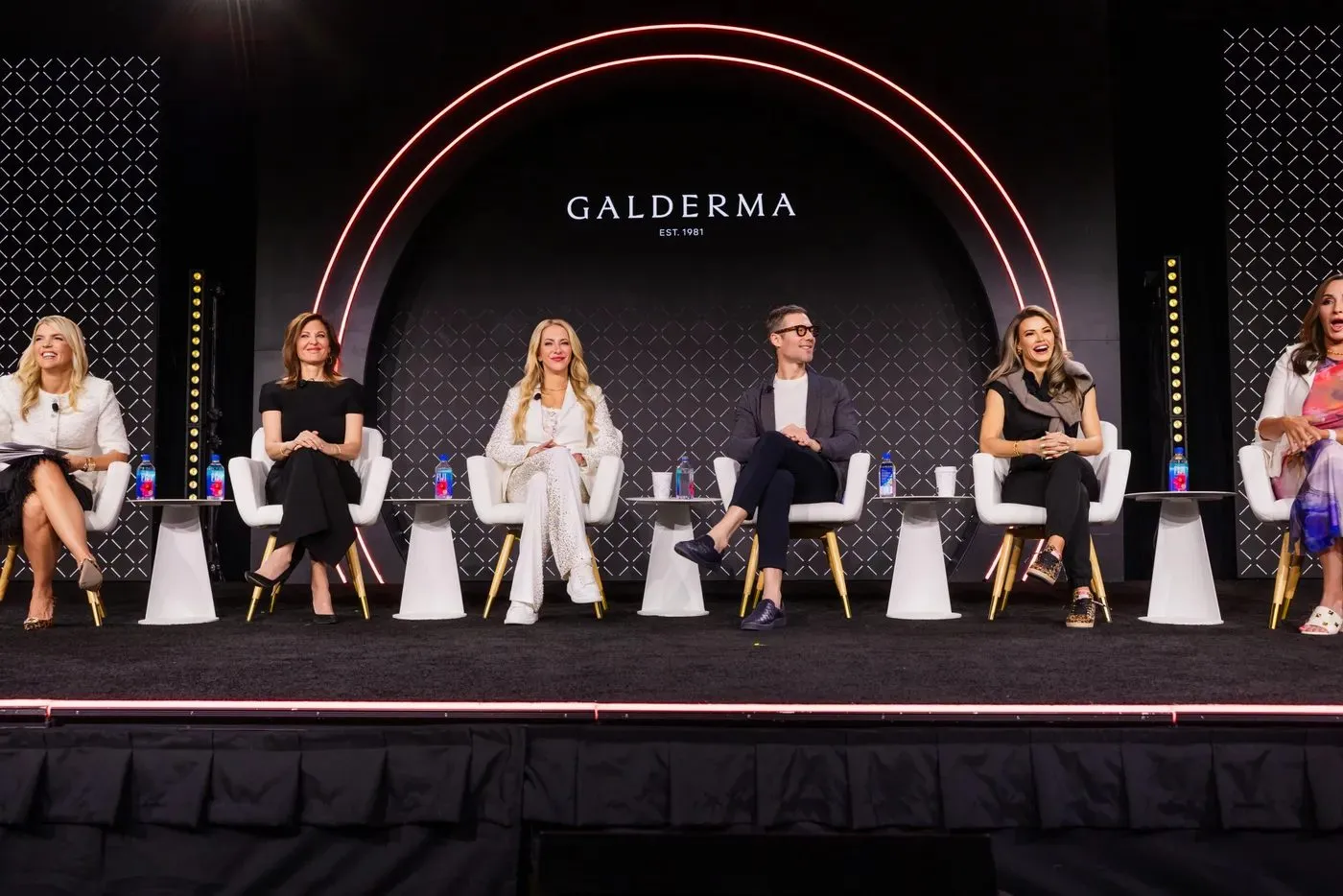 Panel session on a lit main stage at a corporate training program