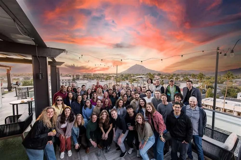 NOYO team on a Scottsdale rooftop at sunset during the retreat welcome party