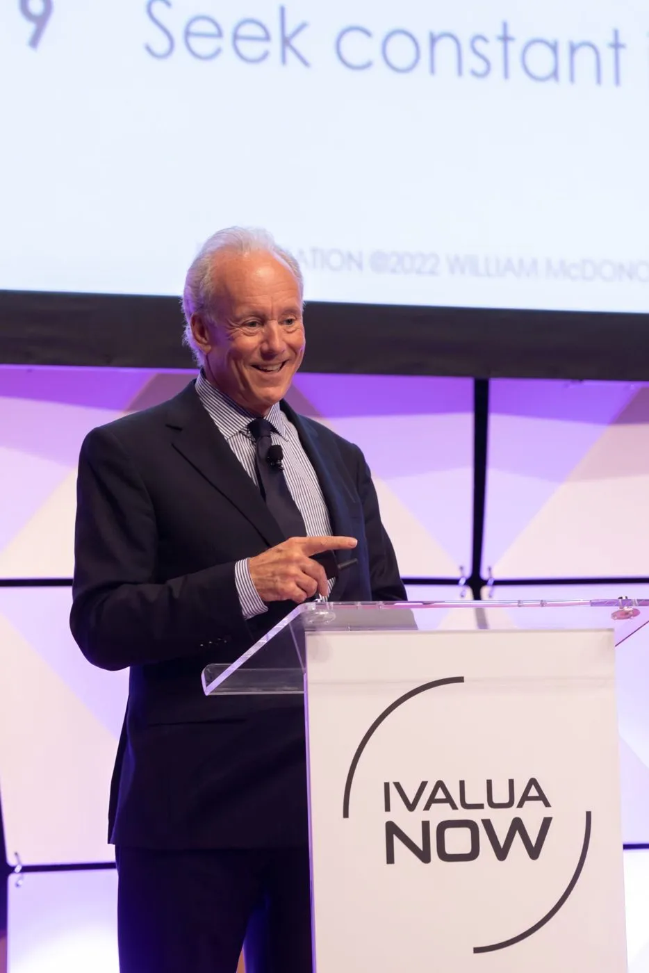 Speaker at a branded podium during a customer conference