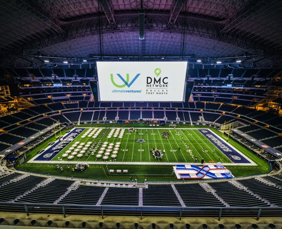 Stadium field with a large screen set up for a group event