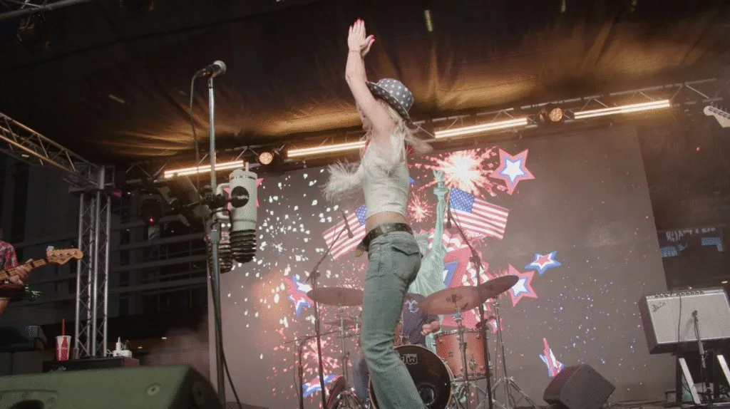 Performer on stage in front of an LED wall at the Westgate Fourth of July concert