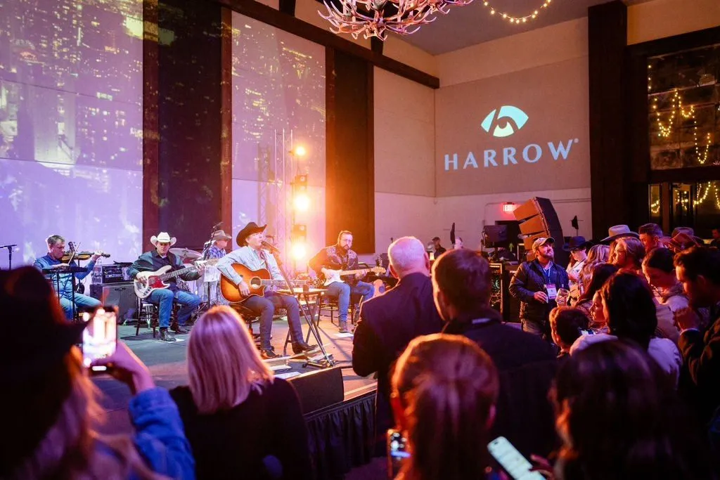 Acoustic band playing for a standing crowd at a branded evening event