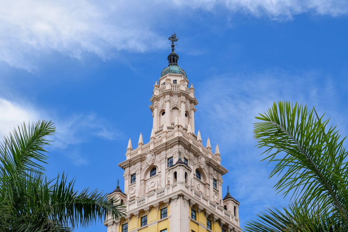 The top of the Freedom Tower in Downtown Miami against a blue sky.